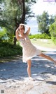 A woman in a white dress is posing for a picture.